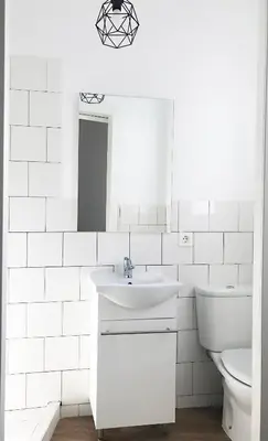 a white bathroom with a sink and a toilet at Goya atico in Valencia