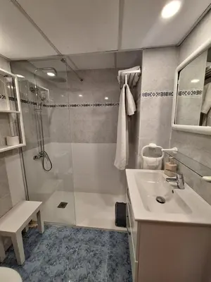 a bathroom with a shower and a sink and a toilet at ValenciaBeachHome in Port Saplaya