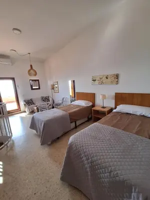 a bedroom with two beds and a living room at ValenciaBeachHome in Port Saplaya
