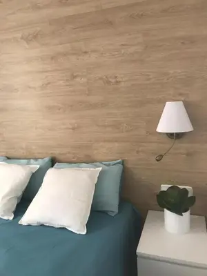 a bedroom with a blue bed with a lamp and pillows at Apartamento Joseph , luminoso, bonito y muy céntrico in Valencia