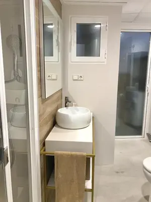 a white bathroom with a sink and a shower at Apartamento Joseph , luminoso, bonito y muy céntrico in Valencia