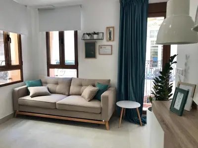 a living room with a couch in front of a window at Apartamento Joseph , luminoso, bonito y muy céntrico in Valencia