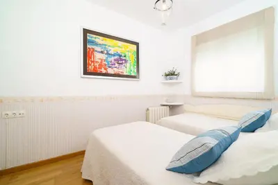 a bedroom with two beds and a painting on the wall at Vivaldi Valencia in Valencia