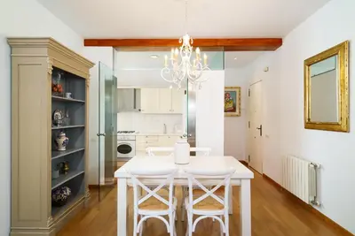 a dining room with a white table and chairs at Vivaldi Valencia in Valencia