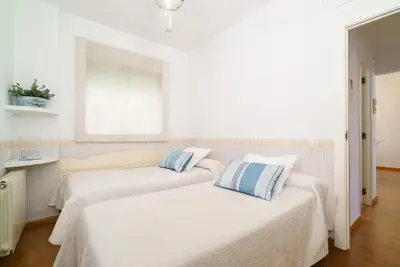 two beds in a room with white walls at Vivaldi Valencia in Valencia