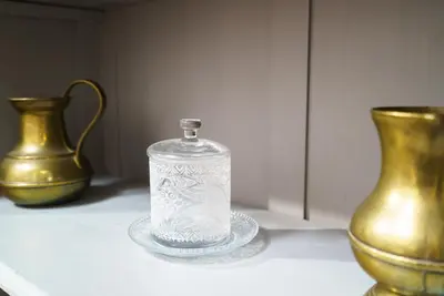 a glass container sitting on a table next to two vases at Vivaldi Valencia in Valencia