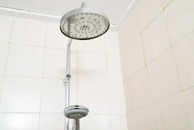 a shower head in a bathroom with white tiles at Vivaldi Valencia in Valencia