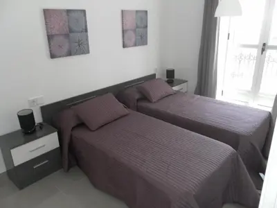 a bedroom with two beds and a window at Carrer de Dénia in Valencia
