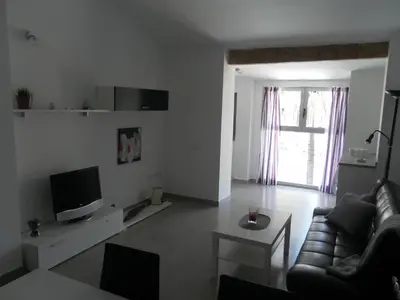 a living room with a couch and a tv and a table at Carrer de Dénia in Valencia