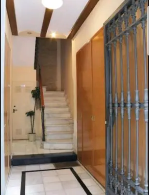 a hallway with a staircase in a building with a door at Junto al Mercado de Ruzafa in Valencia