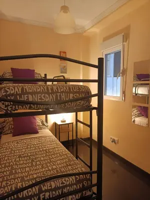 a bedroom with two bunk beds and a window at Habitaciones Centricas en una casa Valenciana in Valencia