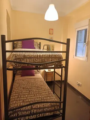 a couple of bunk beds in a room at Habitaciones Centricas en una casa Valenciana in Valencia