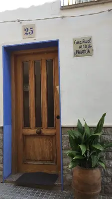 a wooden door of a building with a sign above it at Alto Palancia Calle Progreso 25 Sot de Ferrer in Sot de Ferrer