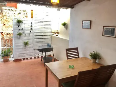 a dining room with a table and a window at Alto Palancia Calle Progreso 25 Sot de Ferrer in Sot de Ferrer