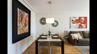 a living room with a table and a couch at Apartamento en la Ciudad de las Ciencias y cerca de la playa in Valencia