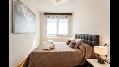 a bedroom with a bed with two towels on it at Apartamento en la Ciudad de las Ciencias y cerca de la playa in Valencia
