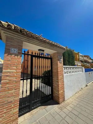 a gate to a building with a brick at Apartamento Barbacoa, Piscina y playa in Puebla de Farnals