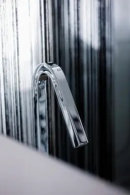 a chrome bathroom sink faucet in front of a mirror at Cool Loft Malvarrosa Beach in Valencia