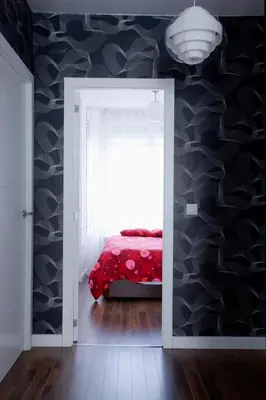 a bedroom with a red bed in a room with a wall at Cool Loft Malvarrosa Beach in Valencia