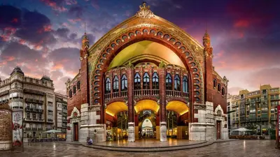 a large building with an arch in a city at Cool Loft Malvarrosa Beach in Valencia