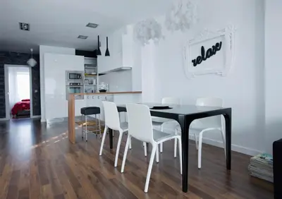 a dining room with a black table and white chairs at Cool Loft Malvarrosa Beach in Valencia