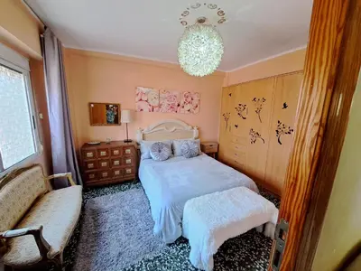 a bedroom with a bed and a chandelier at Full equipped and comfortable apartment with WiFi in Valencia