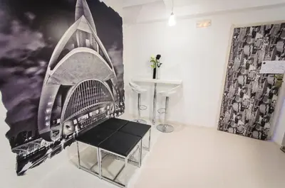 a room with a bench and a wall with a mural at Hostal On Dormire Valencia in Valencia