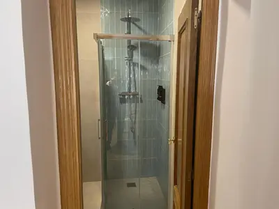 a shower with a glass door in a bathroom at Cabanyal Home in Valencia