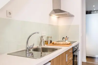 a kitchen with a sink and a stove at Cabanyal Home in Valencia
