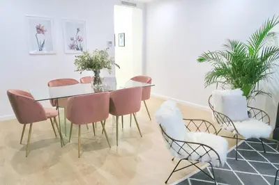 a dining room with a glass table and pink chairs at Paz Velvet, Espectacular Piso en Calle La Paz in Valencia