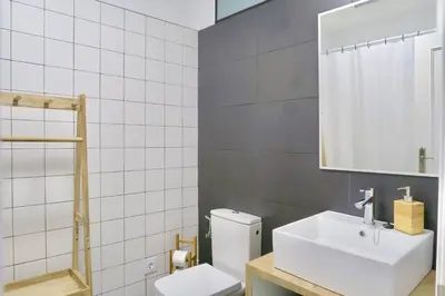 a bathroom with a toilet and a sink and a mirror at Paz Velvet, Espectacular Piso en Calle La Paz in Valencia