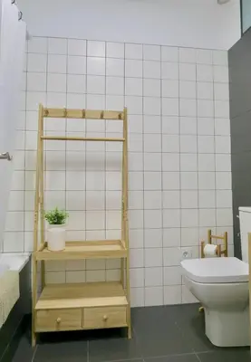 a bathroom with a toilet and a plant on a shelf at Paz Velvet, Espectacular Piso en Calle La Paz in Valencia