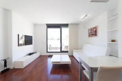 a living room with a white couch and a table at Ático Valencia Centro in Valencia