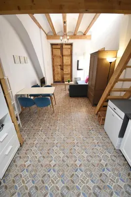 a room with a table and chairs on a tile floor at Apartamento cerca de la playa in Valencia