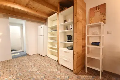 a room with white shelves and a refrigerator at Apartamento cerca de la playa in Valencia