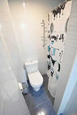 a bathroom with a white toilet in a stall at Apartamento cerca de la playa in Valencia