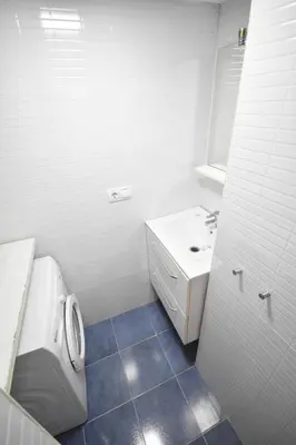 a white bathroom with a toilet and a sink at Apartamento cerca de la playa in Valencia