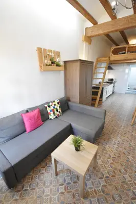 a living room with a couch and a table at Apartamento cerca de la playa in Valencia