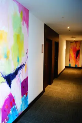 a hallway with two paintings on the wall at Hotel Sercotel Plana Parc in Alquerías del Niño Perdido