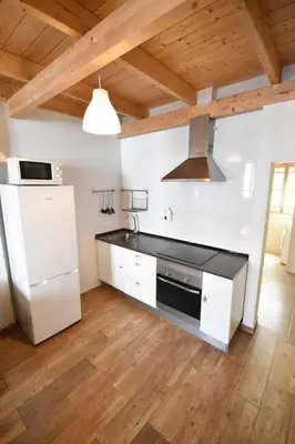 a kitchen with a white refrigerator and a stove at Apartamento en casa historica en la playa in Valencia