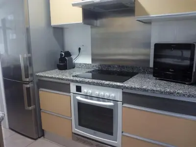 a kitchen with a stove and a microwave at PATACONA MARE NOSTRUM APARTMENT in Valencia