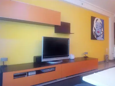 a flat screen tv on a dresser in a room at PATACONA MARE NOSTRUM APARTMENT in Valencia