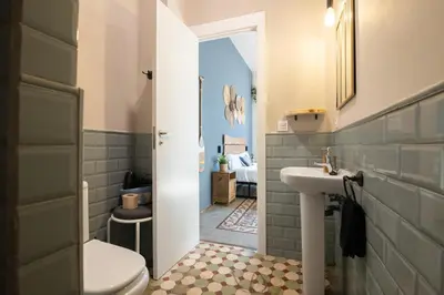 a bathroom with a toilet and a sink at Bird House in Valencia