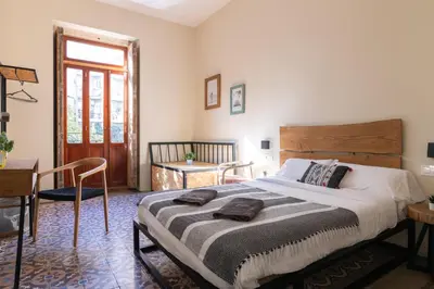 a bedroom with a large bed with a wooden headboard at Bird House in Valencia