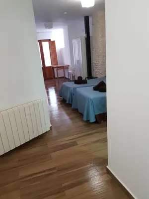 a bedroom with a bed and a wooden floor at PLAZA REDONDA brugada home in Valencia