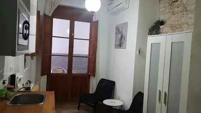 a kitchen with a window and a table and chairs at PLAZA REDONDA brugada home in Valencia