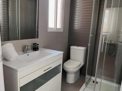 a bathroom with a toilet and a sink and a shower at Valencia Luxury - Boutique Market in Valencia