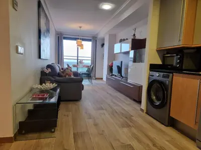 a living room with a couch and a washer at Apto en Ciudad de las Ciencias y cerca playa in Valencia