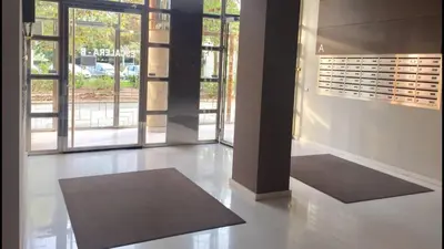 a large room with a wall of glass doors and a rug at Apto en Ciudad de las Ciencias y cerca playa in Valencia