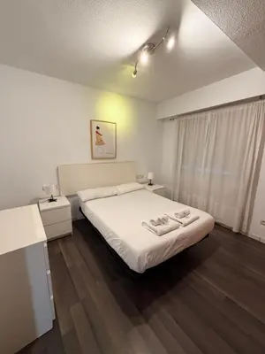 a bedroom with a bed with two towels on it at Zerka Centro in Valencia